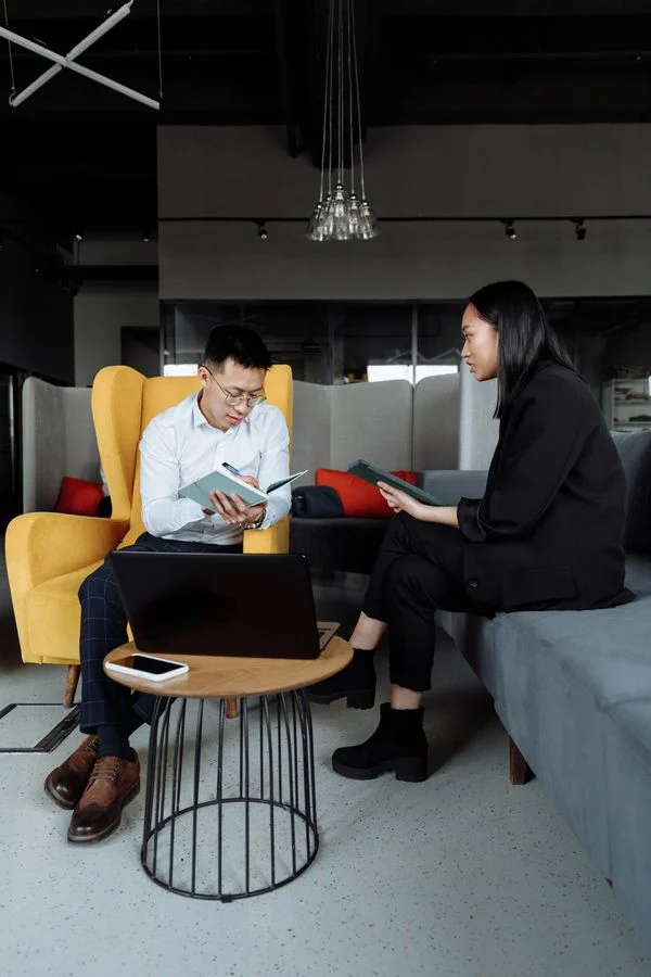 Building Portfolio That Gets - Freelancers reviewing project documents together in an office