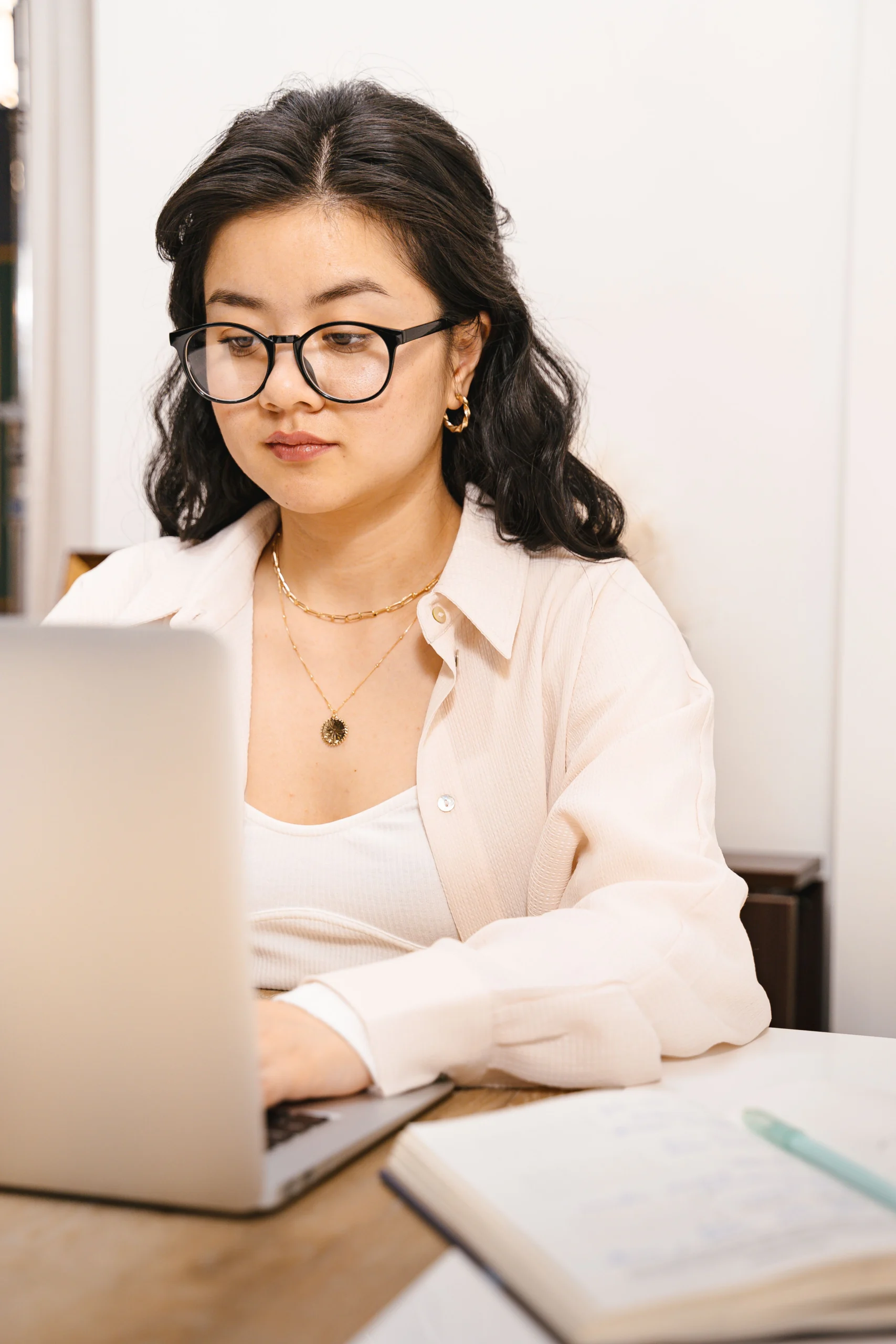 Gpt Claude Gemini Which - Woman working on a laptop, comparing AI tools