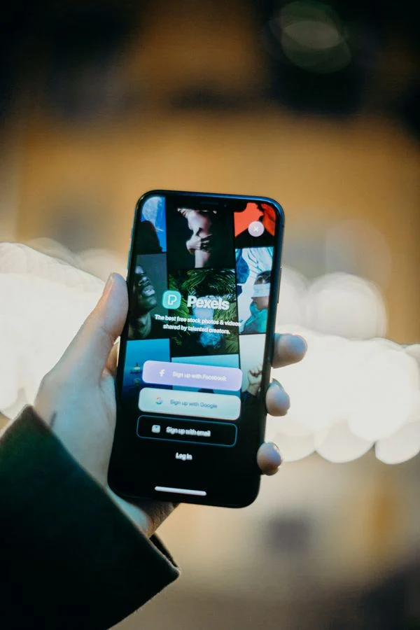App Stores Work Flathub - Hand holding a smartphone showing an app