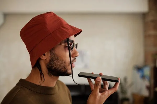Live Translation Works Google - Person using a smartphone with a microphone for live speech translation