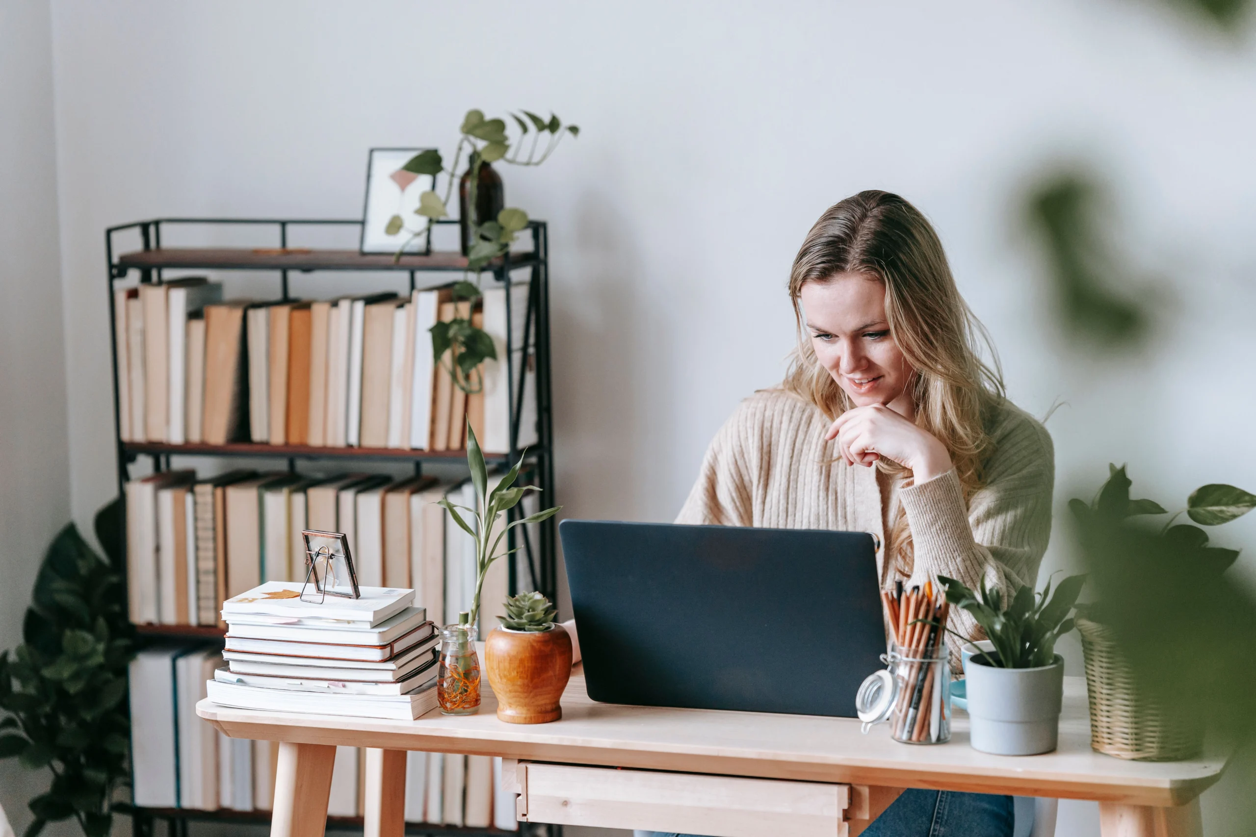 Write Freelance Proposals That - Freelancer working on a laptop at home writing a client proposal