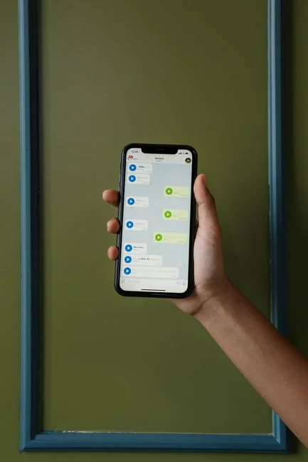 What Is AI Memory / AI Memory - Hand holding a smartphone showing a chat conversation