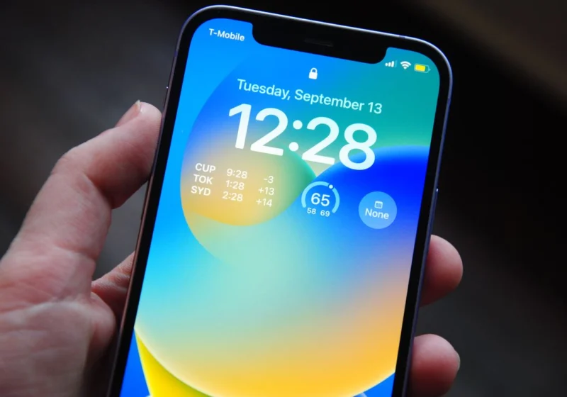 Pexels (photo ID 13628543) — free to use under the Pexels license; photographer name not present in returned metadata. Verified: hand holding an iPhone showing its lock screen (landscape, 1120x750).