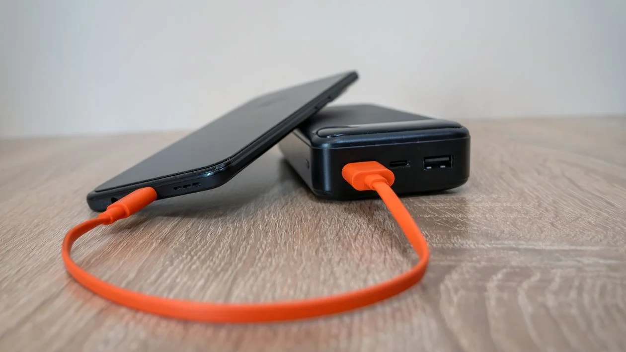 What Is Usb-c - Smartphone charging from a power bank with an orange USB-C cable